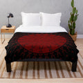 Maroon plush blanket with night sky and celestial motifs inspired by Native American art