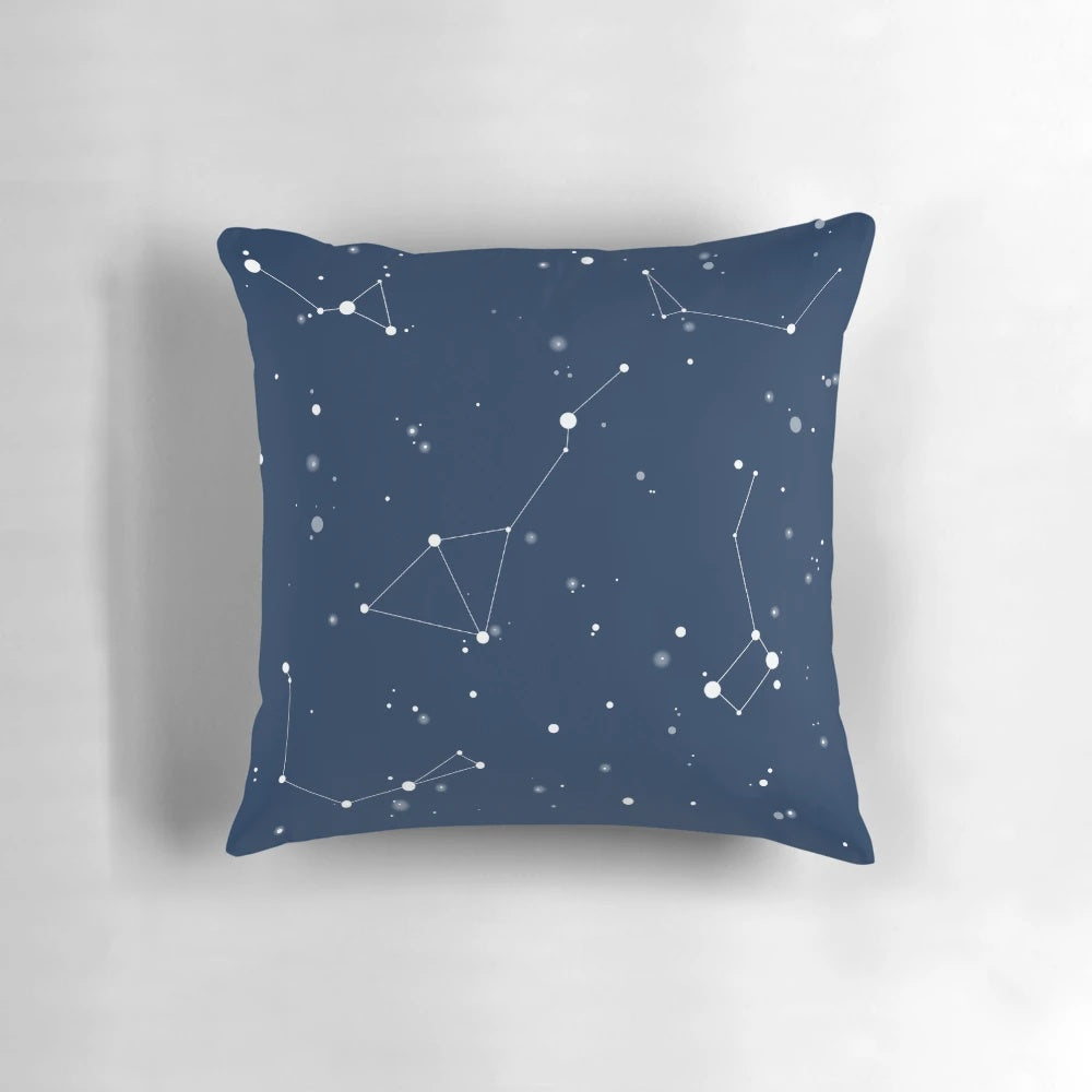 A navy blue pillow featuring a captivating night sky design with star constellations and the north star.