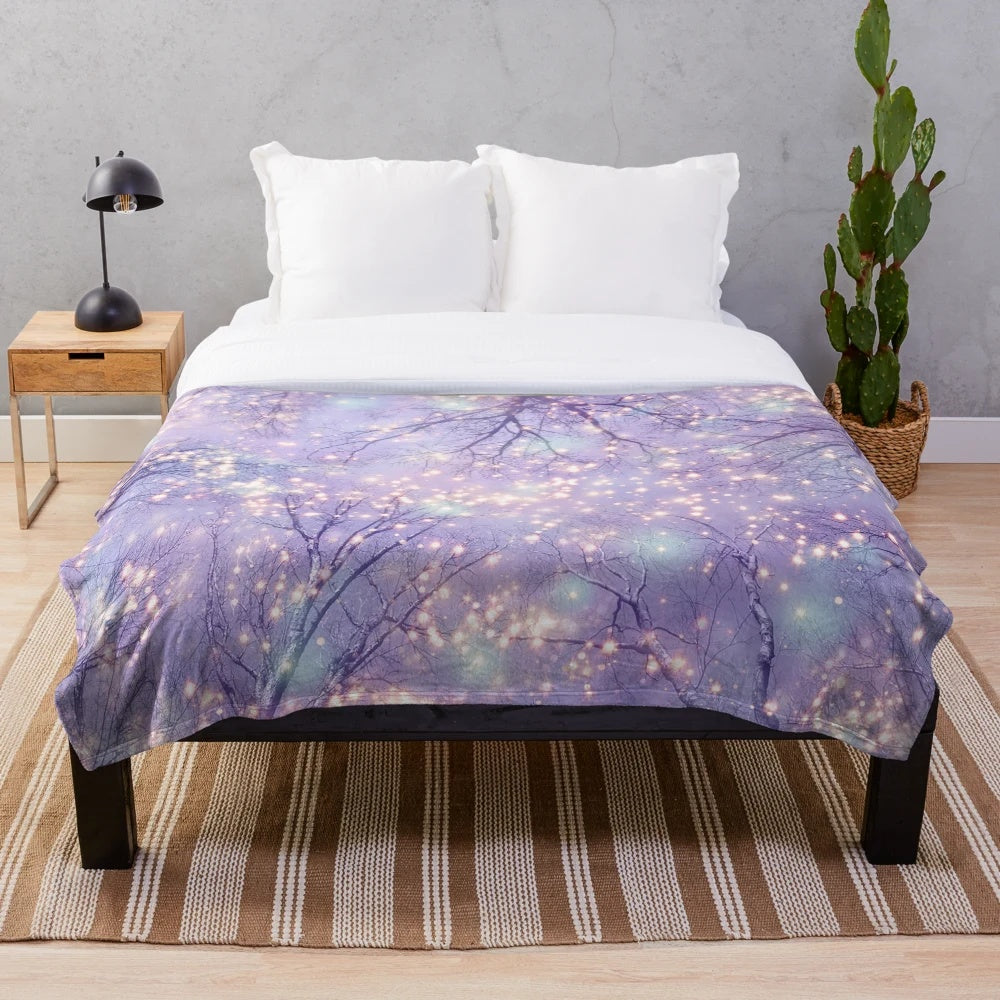 Plush blanket with night sky, stars, and tree silhouette design