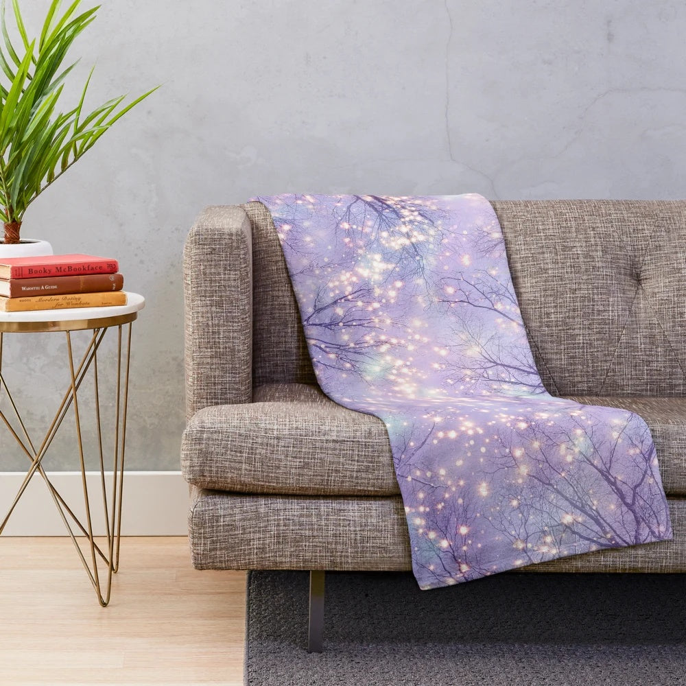 Plush blanket with night sky, stars, and tree silhouette design