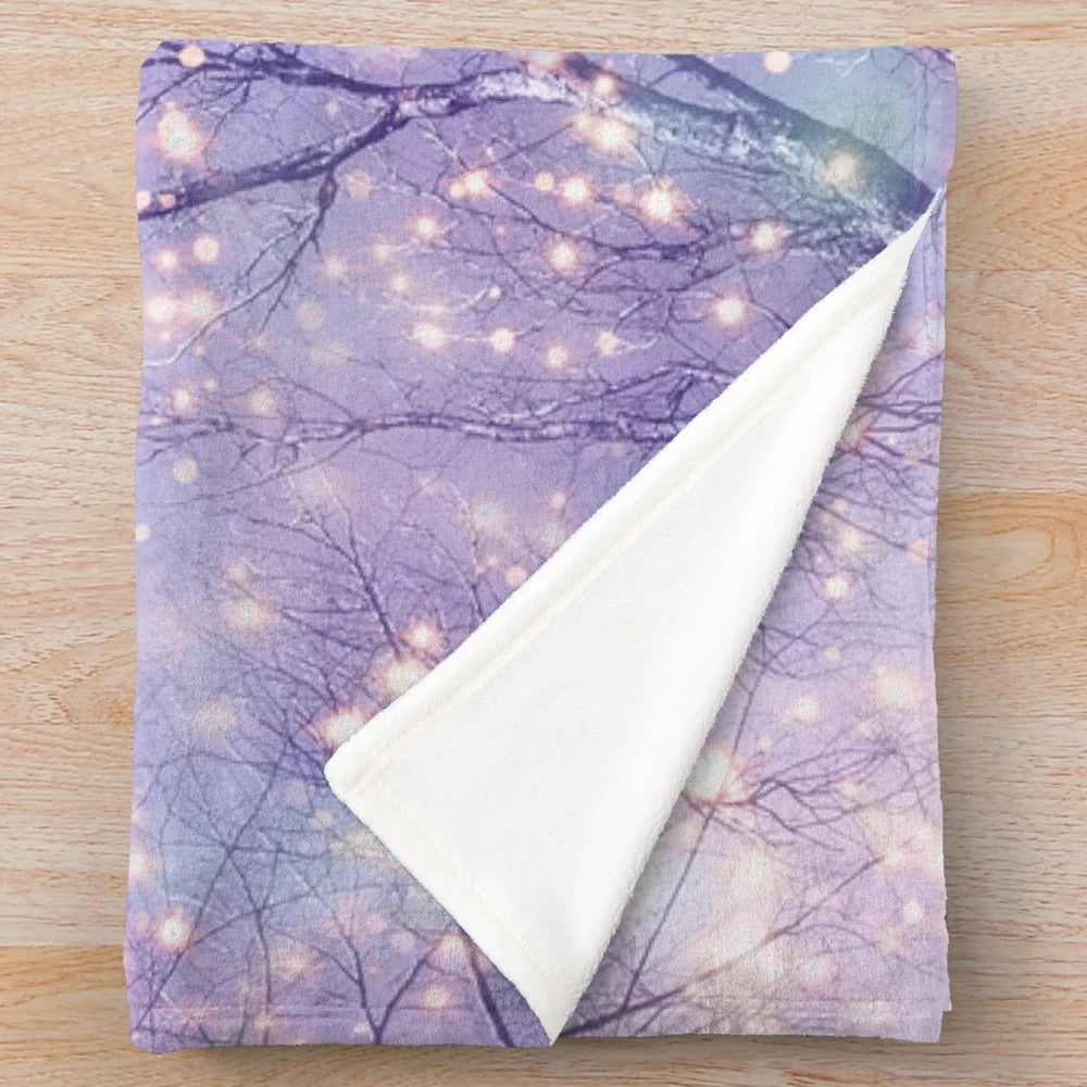 Plush blanket with night sky, stars, and tree silhouette design