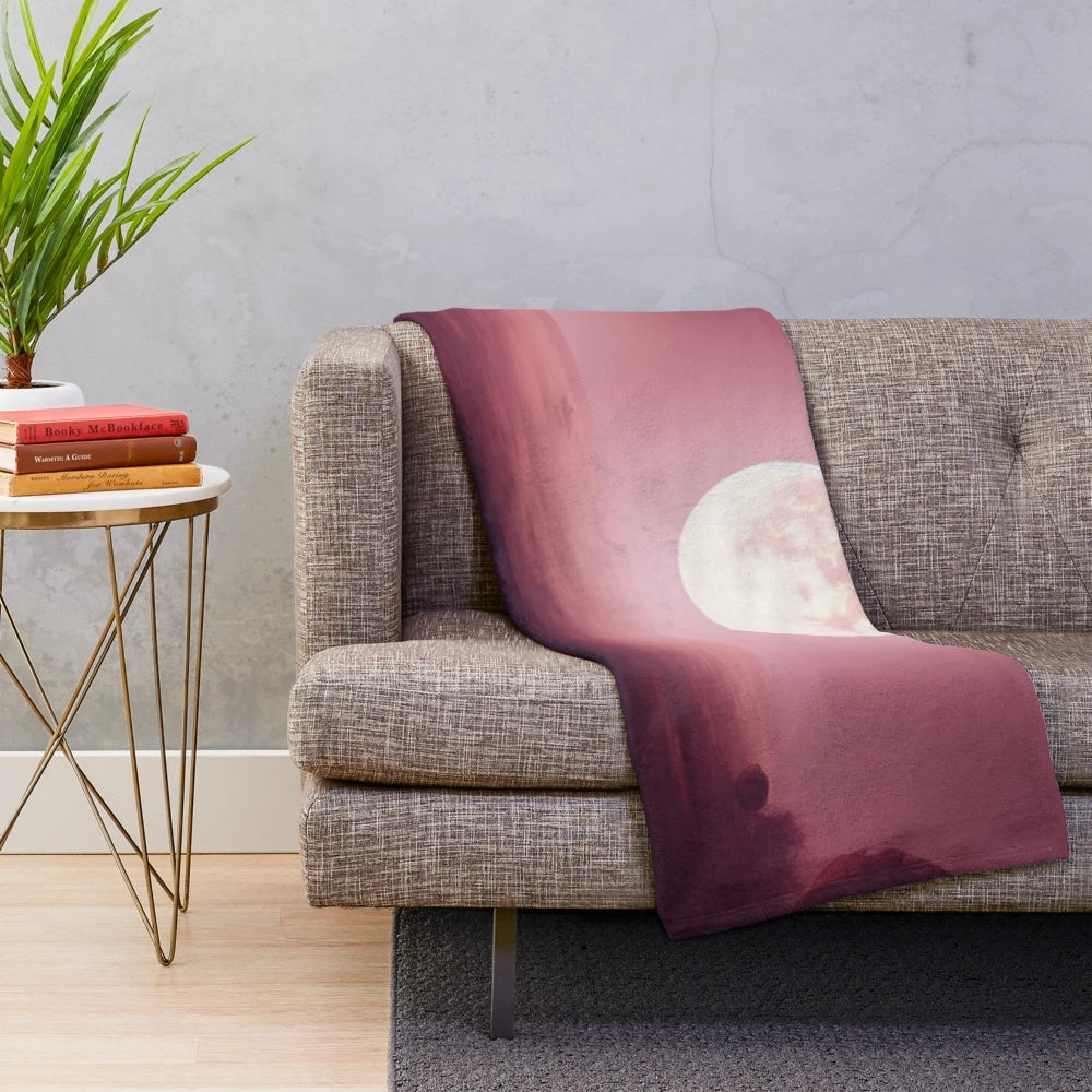 Plush blanket featuring a moon from another planet design, perfect for cinema and movie lovers