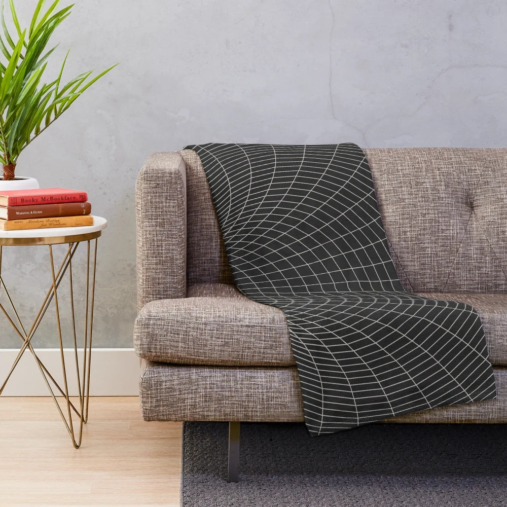 A plush, cozy blanket featuring a cosmic, sci-fi inspired design with elements like black holes, event horizons, and galaxies.