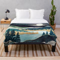 Plush blanket with a nature-inspired celestial design featuring stars, a mountain lake, and evergreen forest