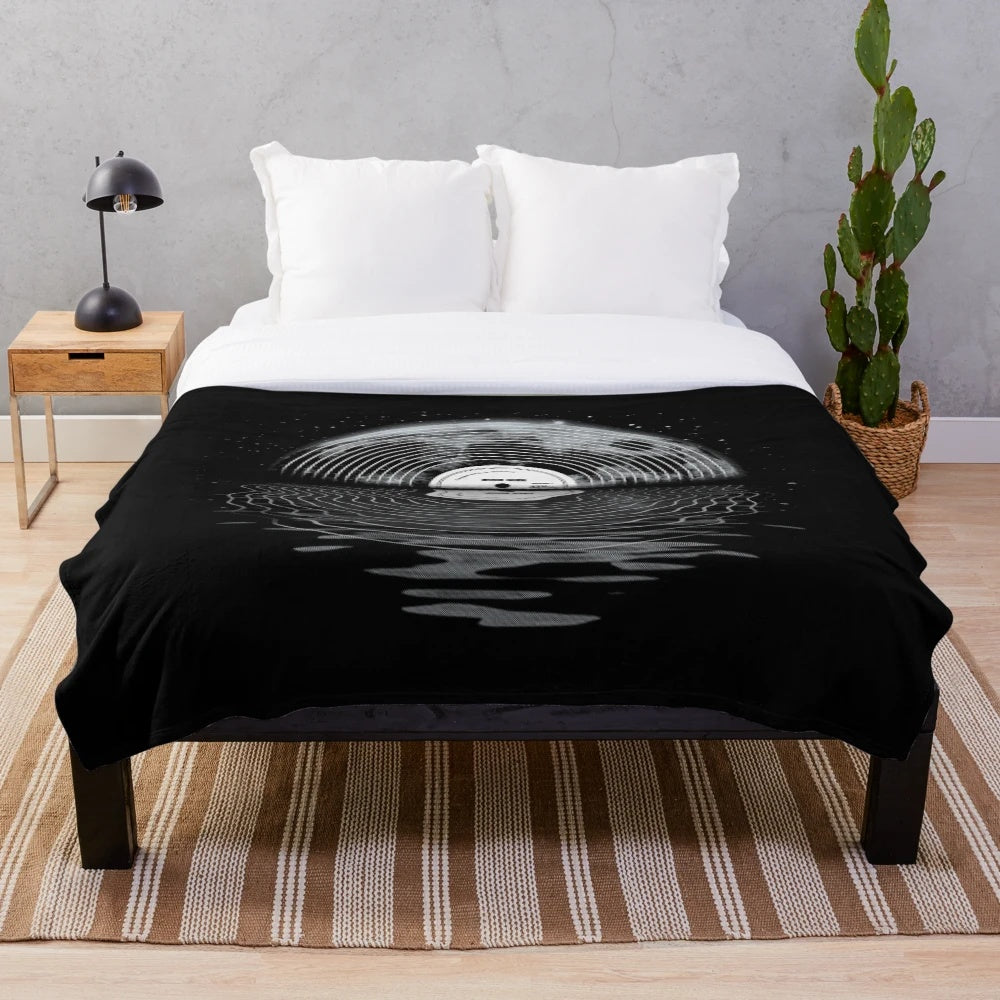 Cozy plush blanket featuring a moon and stars design