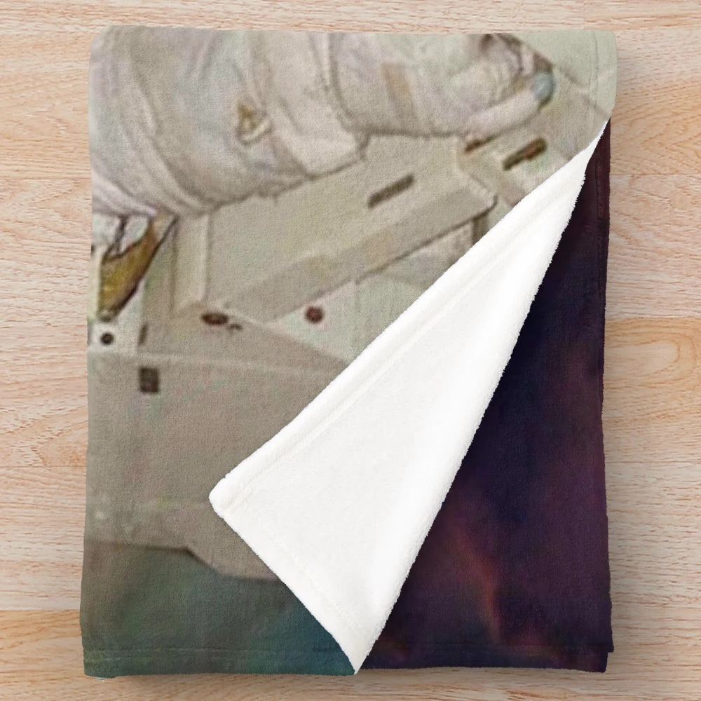 Plush blanket with a sci-fi, space-themed design featuring astronauts, planets, and a colorful galaxy