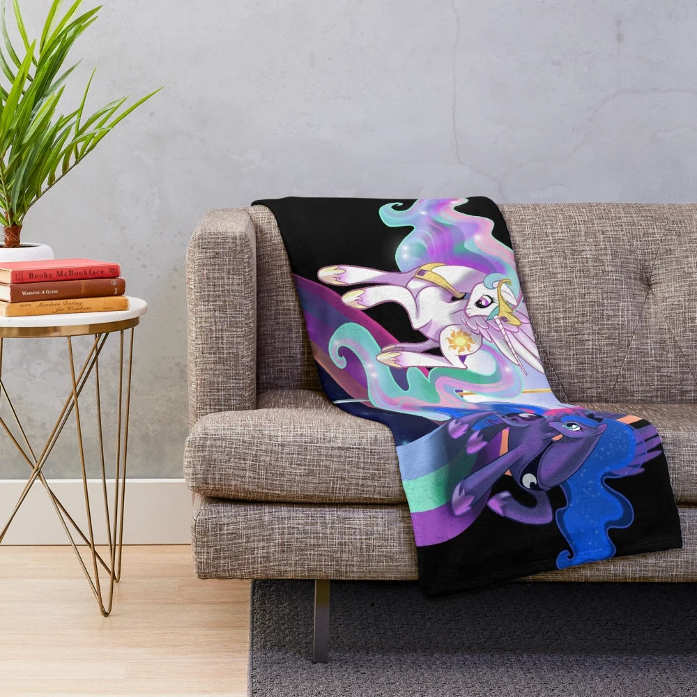 Colorful plush blanket featuring the princesses of the sun and moon from My Little Pony