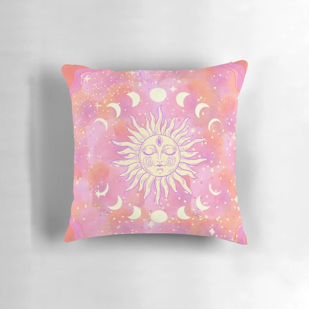 Decorative celestial-themed pink pillow with stars, sun, and moon design