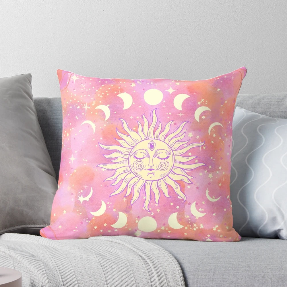 Decorative celestial-themed pink pillow with stars, sun, and moon design