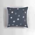 Stamped star patterned decorative pillow for a cozy bedroom or living room.