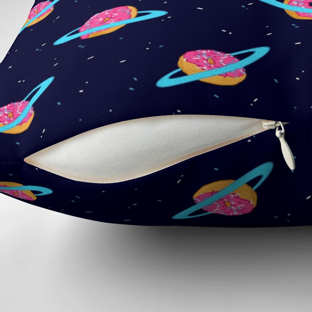 A plush, galaxy-inspired pillow featuring a whimsical design of Saturn's rings made of sweet, chocolate-coated doughnuts against a backdrop of stars.