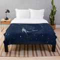Starry whale plush blanket featuring a cosmic dreamscape design
