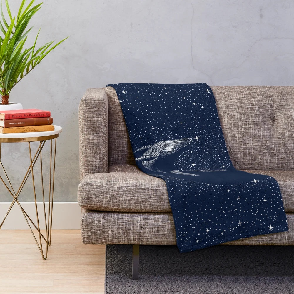 Starry whale plush blanket featuring a cosmic dreamscape design