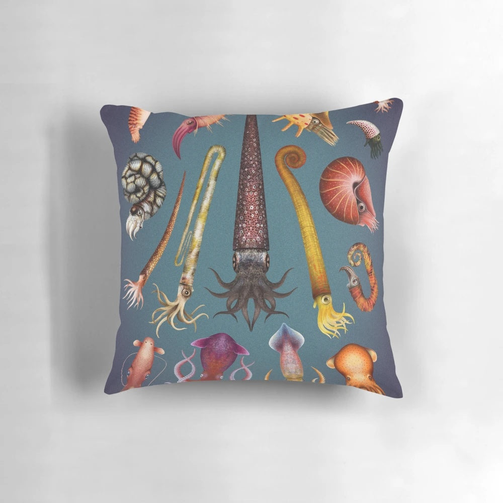 Decorative pillow featuring a cephalopod-inspired design, including squid, octopus, ammonite, and nautilus elements.