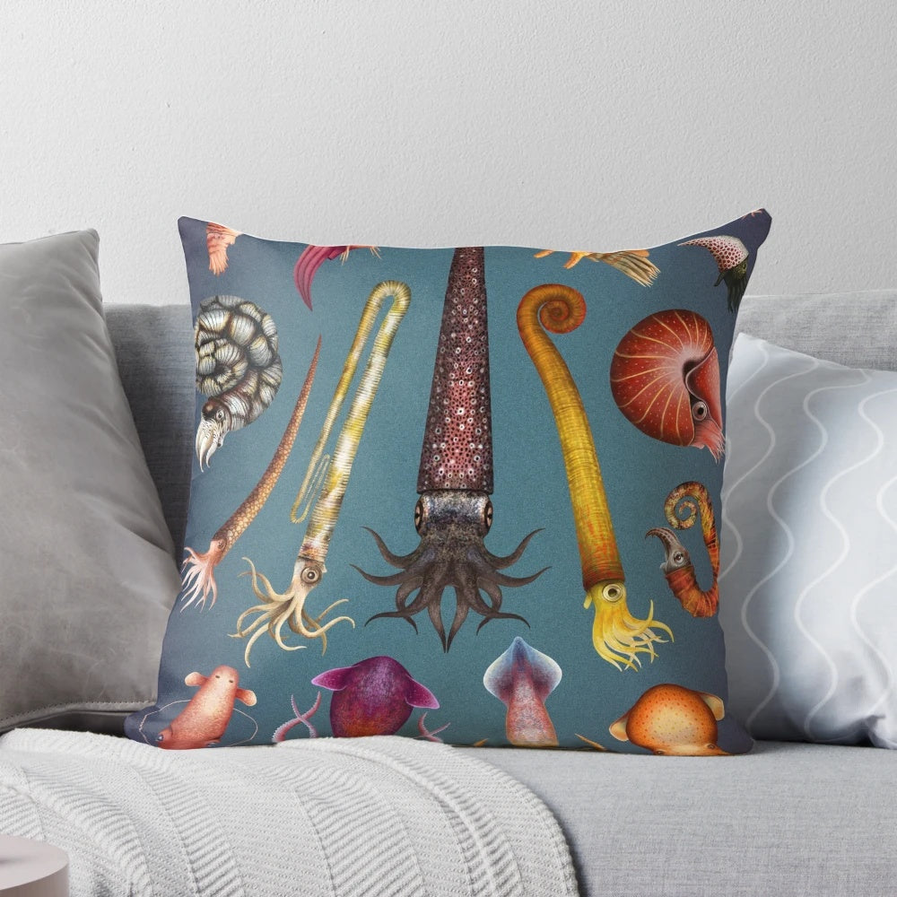 Decorative pillow featuring a cephalopod-inspired design, including squid, octopus, ammonite, and nautilus elements.