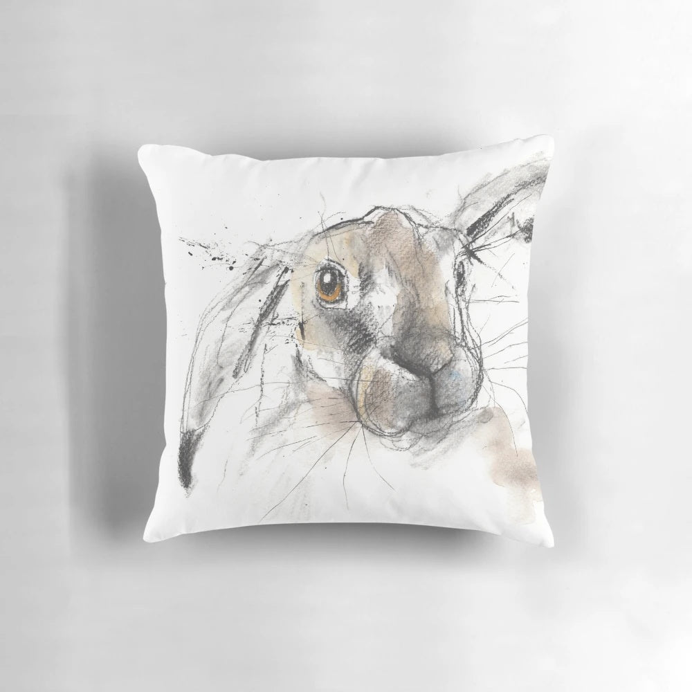 Charcoal sketch illustration of a European hare or rabbit on a decorative throw pillow