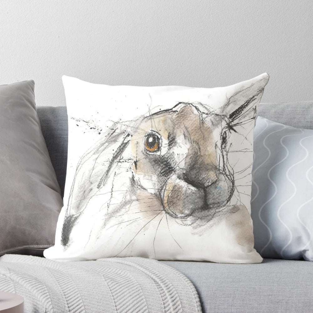 Charcoal sketch illustration of a European hare or rabbit on a decorative throw pillow