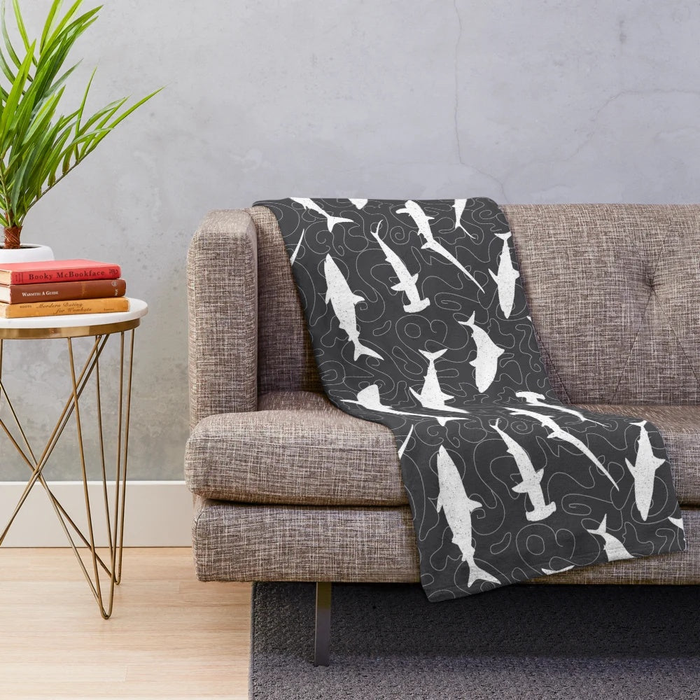 Charcoal grey plush blanket with a shark frenzy pattern design