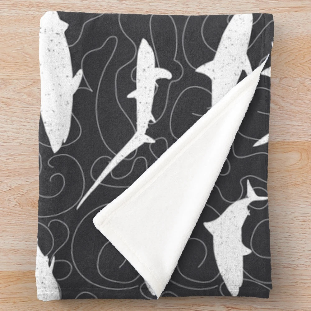 Charcoal grey plush blanket with a shark frenzy pattern design