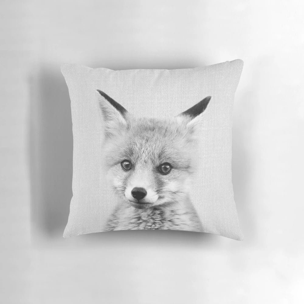 A black and white portrait illustration of a cute baby fox on a decorative throw pillow