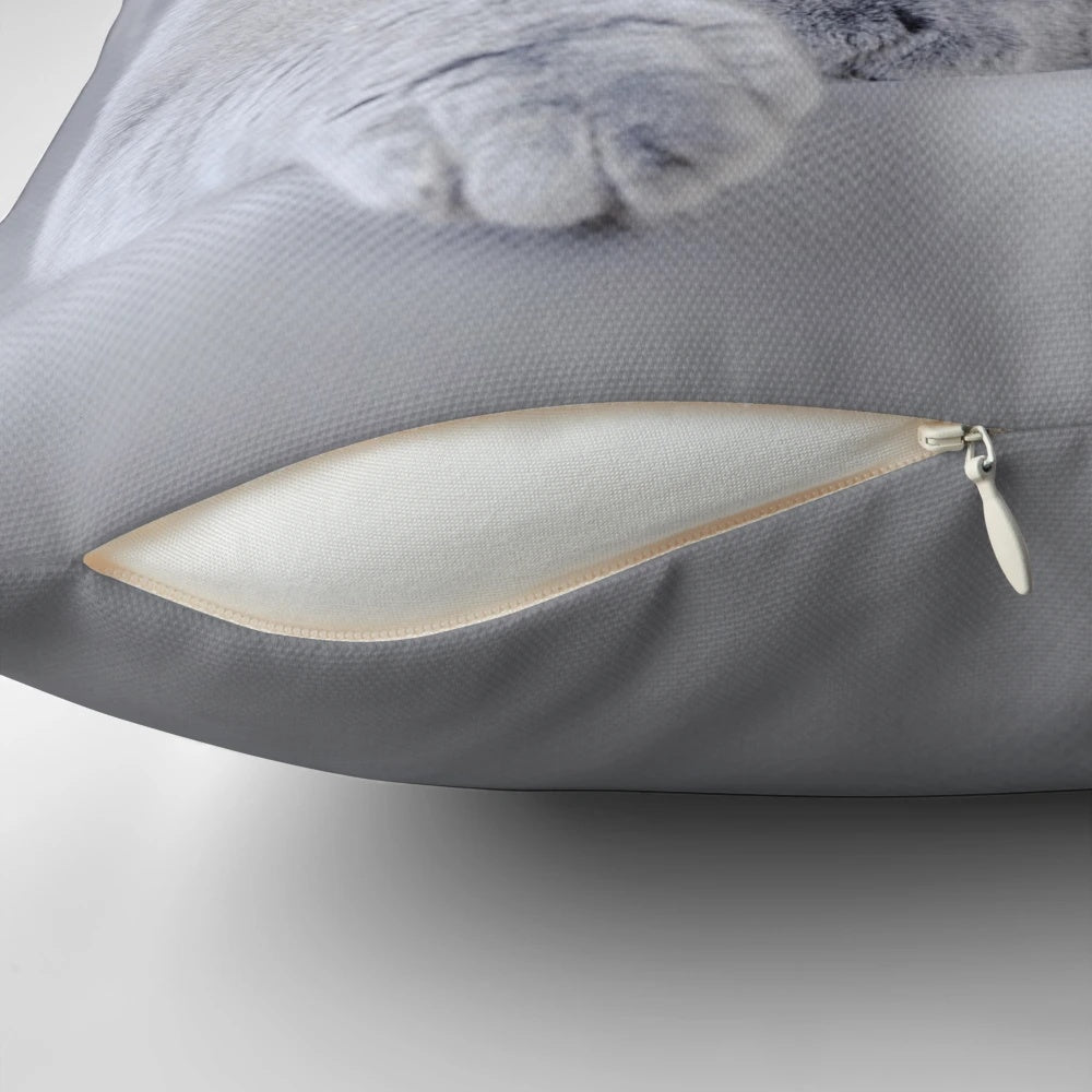 A cozy pillow featuring a detailed portrait of a beautiful British Shorthair cat.