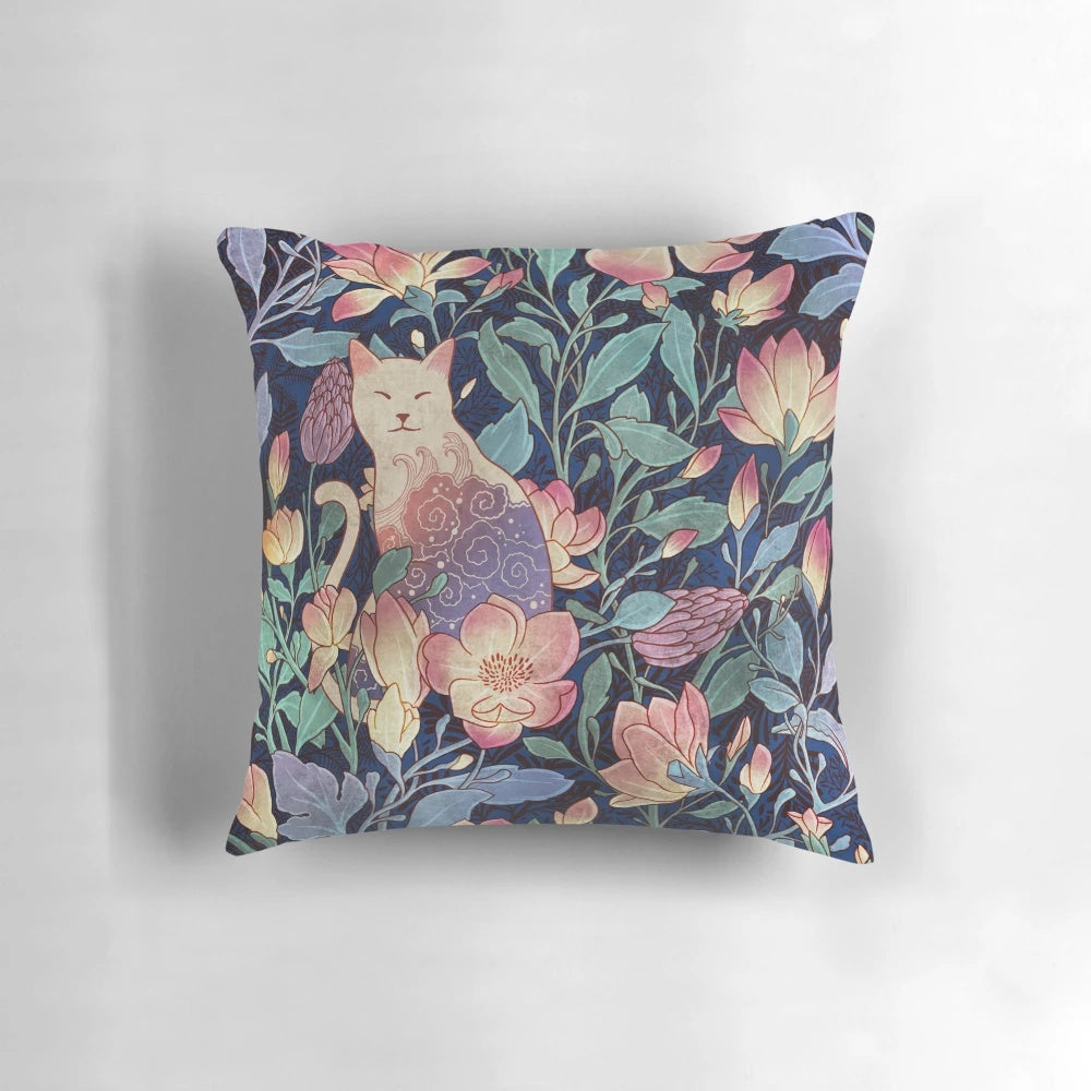 A decorative throw pillow featuring a vintage-inspired pattern with a cat and magnolia flowers.