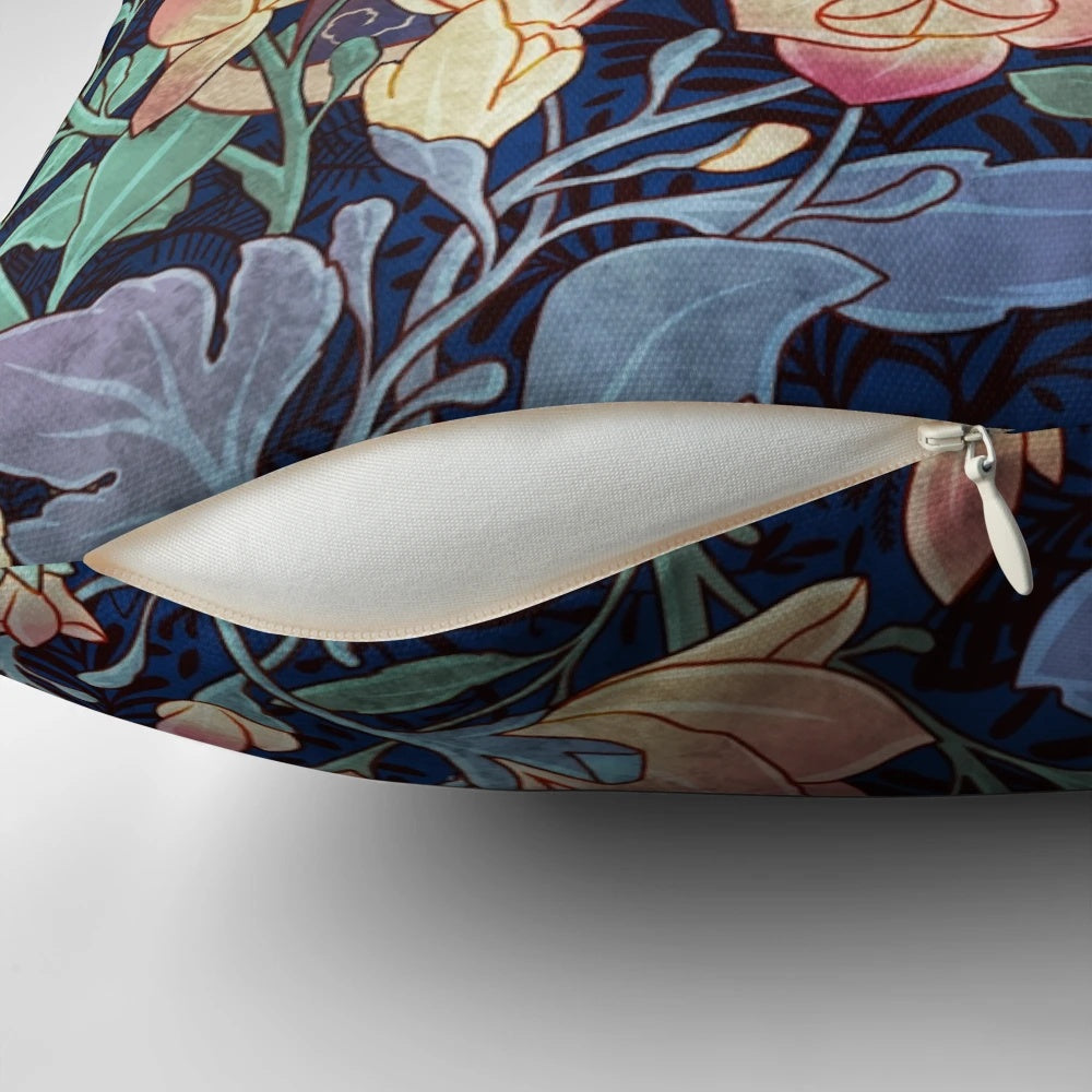 A decorative throw pillow featuring a vintage-inspired pattern with a cat and magnolia flowers.