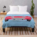 Cherry red plush blanket featuring a frog-eye/bug-eye design inspired by the Austin Healey Sprite