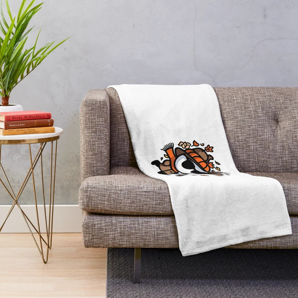 Whimsical chibi characters and stickman figures on a cozy autumn-themed plush blanket