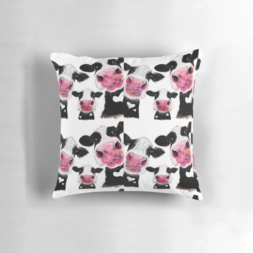 Colorful throw pillow featuring a whimsical cow print design by artist Shirley MacArthur.