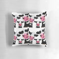Colorful throw pillow featuring a whimsical cow print design by artist Shirley MacArthur.