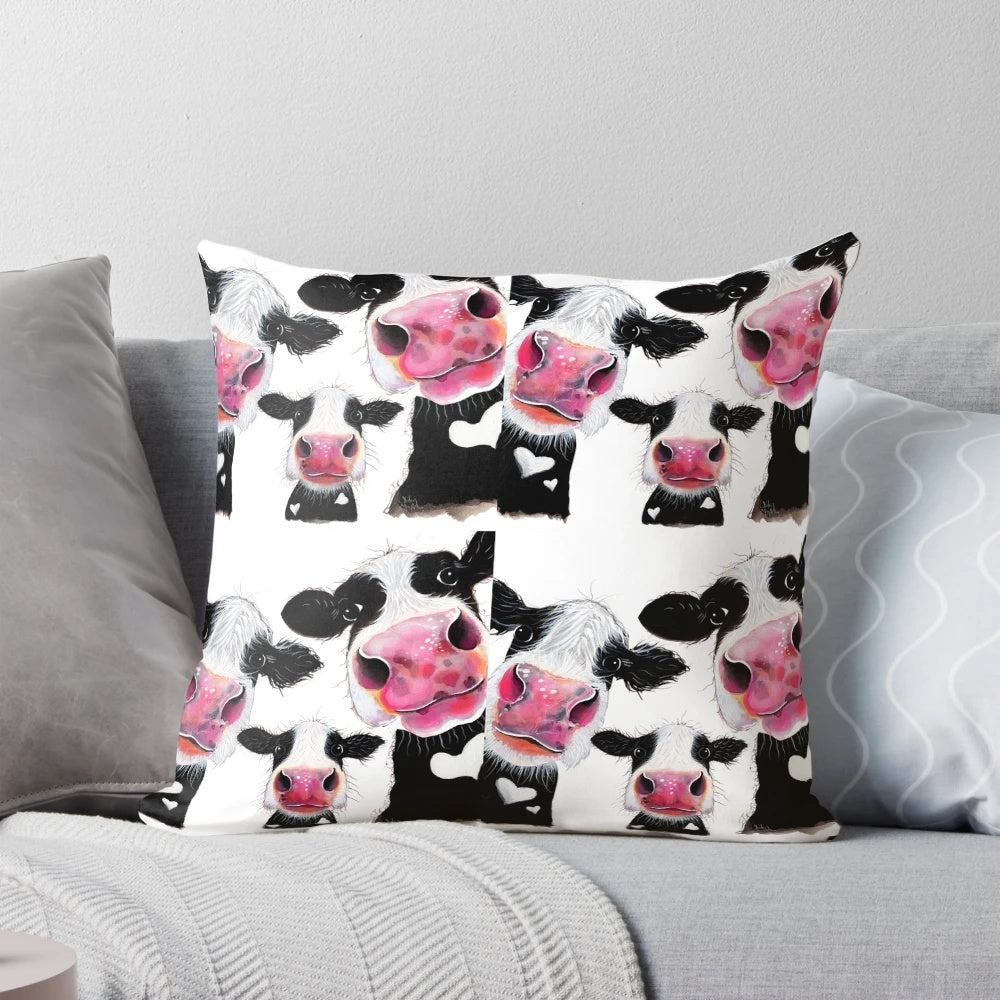 Colorful throw pillow featuring a whimsical cow print design by artist Shirley MacArthur.