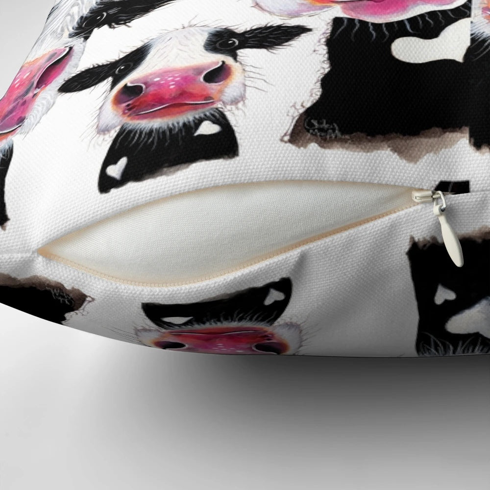 Colorful throw pillow featuring a whimsical cow print design by artist Shirley MacArthur.