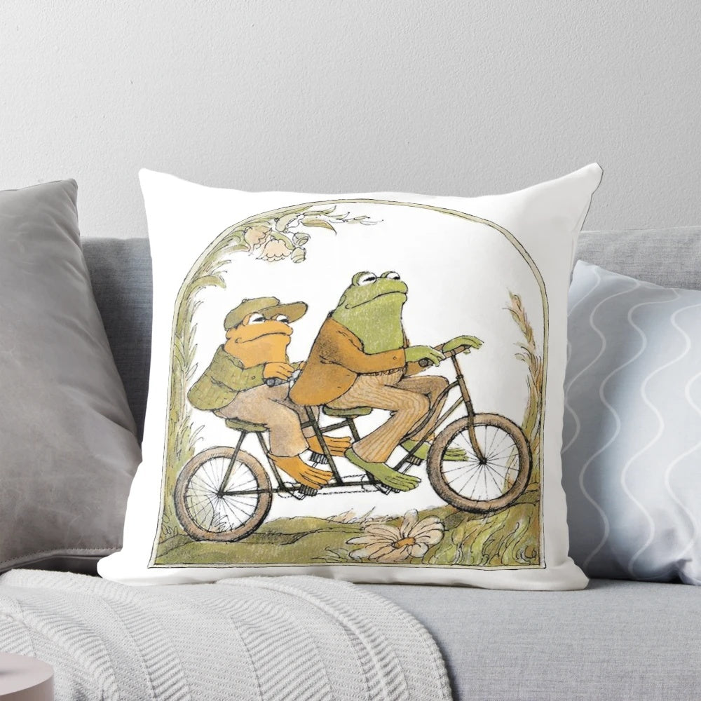 A cozy pillow featuring an illustration of two whimsical amphibian friends, perfect for adding a touch of nature-inspired style to your home.