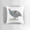 Close-up of a decorative guinea fowl-themed throw pillow with a painted bird design