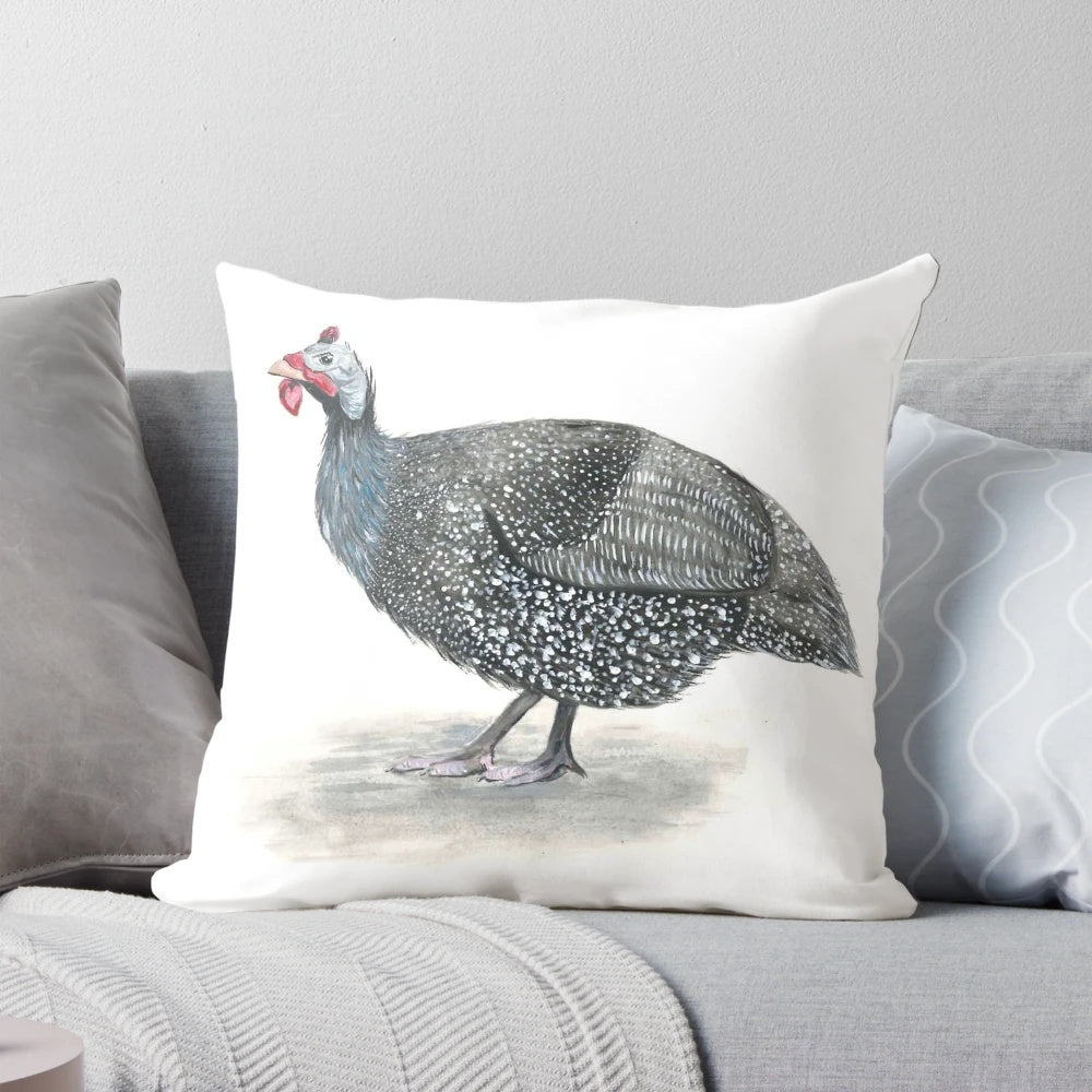 Close-up of a decorative guinea fowl-themed throw pillow with a painted bird design