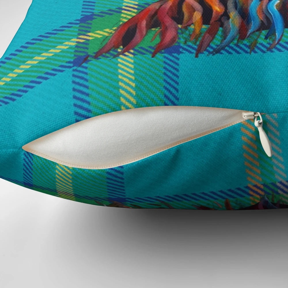 A soft, cozy pillow featuring a hand-painted highland cow in a vibrant tartan pattern.
