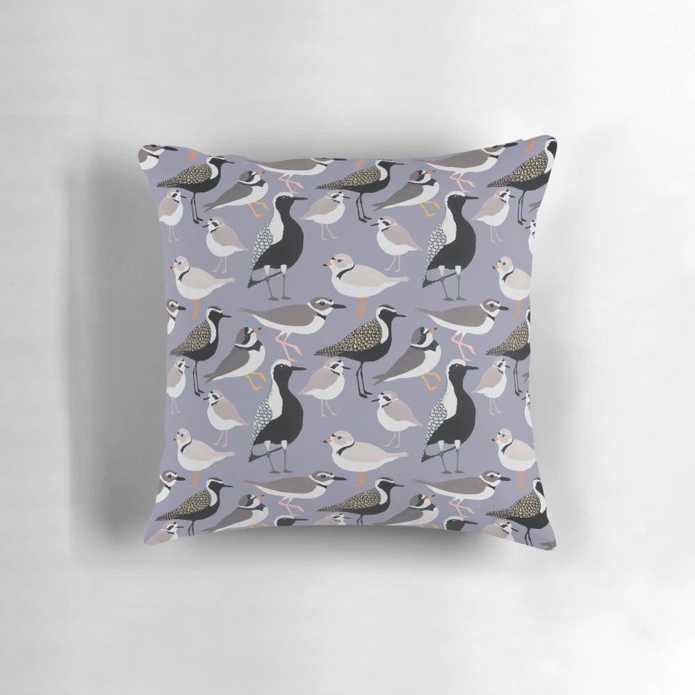 Colorful pillow featuring a design of adorable plovers on a sandy beach