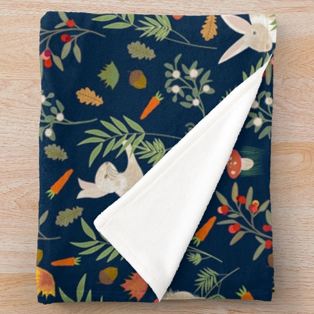 Plush blanket with a happy rabbit pattern in a botanical, nature-inspired design