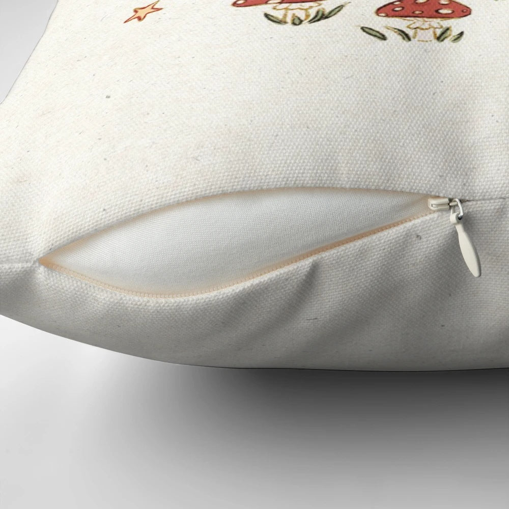 A soft, decorative throw pillow featuring a whimsical illustration of a raccoon surrounded by mushrooms and botanical elements in a nature-inspired, cottagecore design.