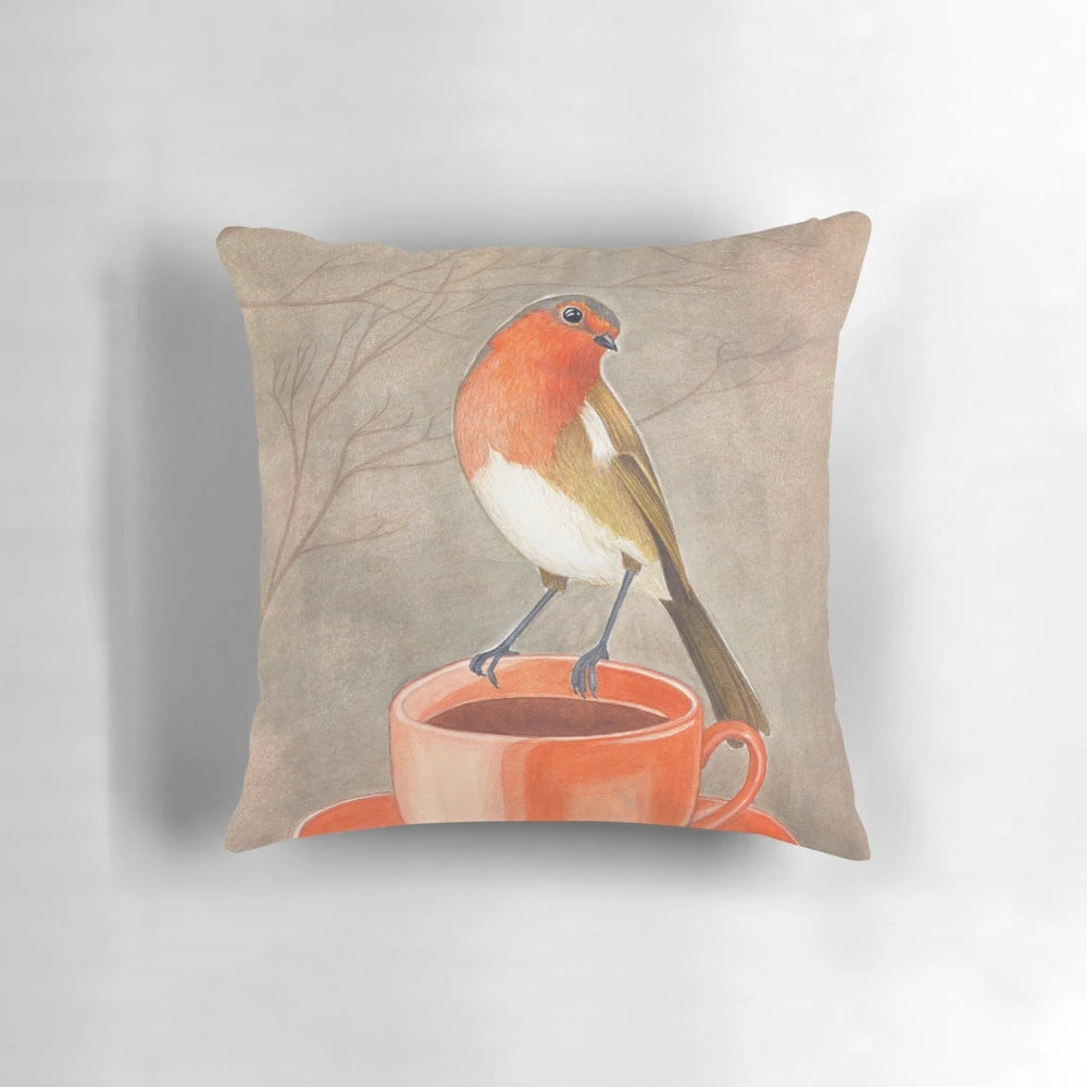 A watercolor illustration of a robin bird perched on a coffee mug, creating a cozy and whimsical coffee-themed pillow design.