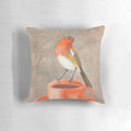 A watercolor illustration of a robin bird perched on a coffee mug, creating a cozy and whimsical coffee-themed pillow design.