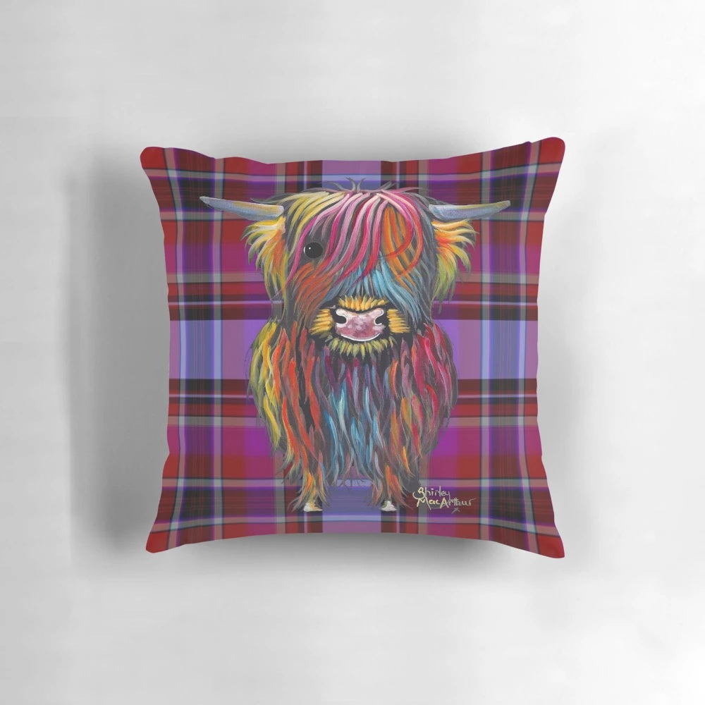 A colorful pillow featuring a whimsical illustration of a friendly highland cow in a tartan pattern.