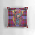 A colorful pillow featuring a whimsical illustration of a friendly highland cow in a tartan pattern.