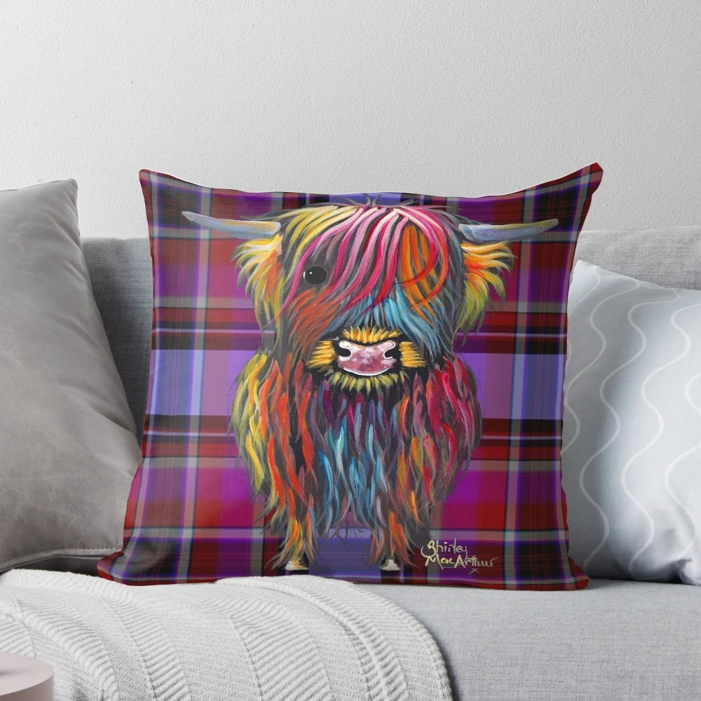 A colorful pillow featuring a whimsical illustration of a friendly highland cow in a tartan pattern.