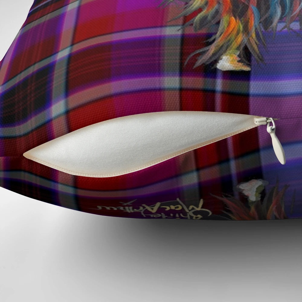 A colorful pillow featuring a whimsical illustration of a friendly highland cow in a tartan pattern.