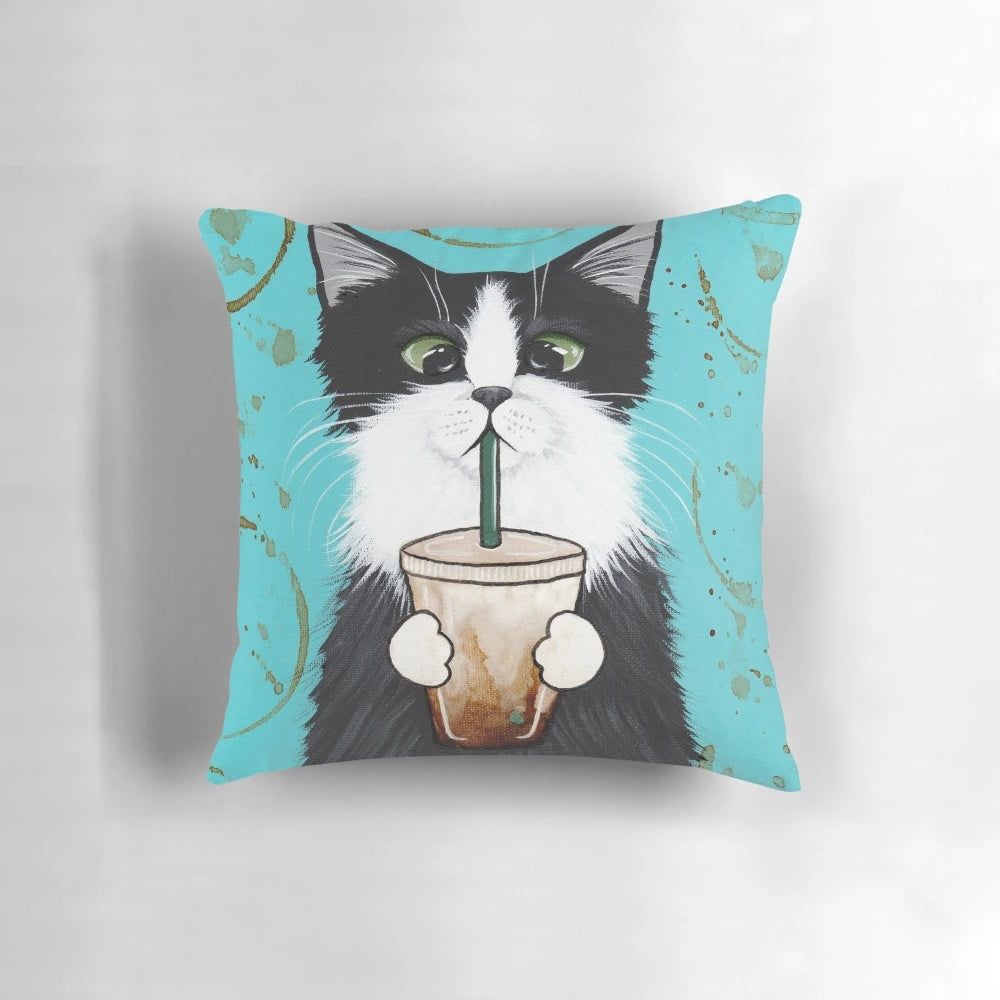 A decorative pillow featuring a cute tuxedo cat design with an iced coffee motif.