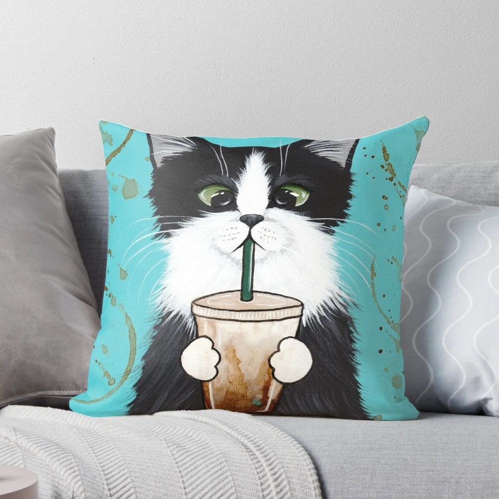 A decorative pillow featuring a cute tuxedo cat design with an iced coffee motif.