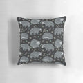 Decorative throw pillow with a whimsical repeat pattern of cute raccoons in a woodland setting
