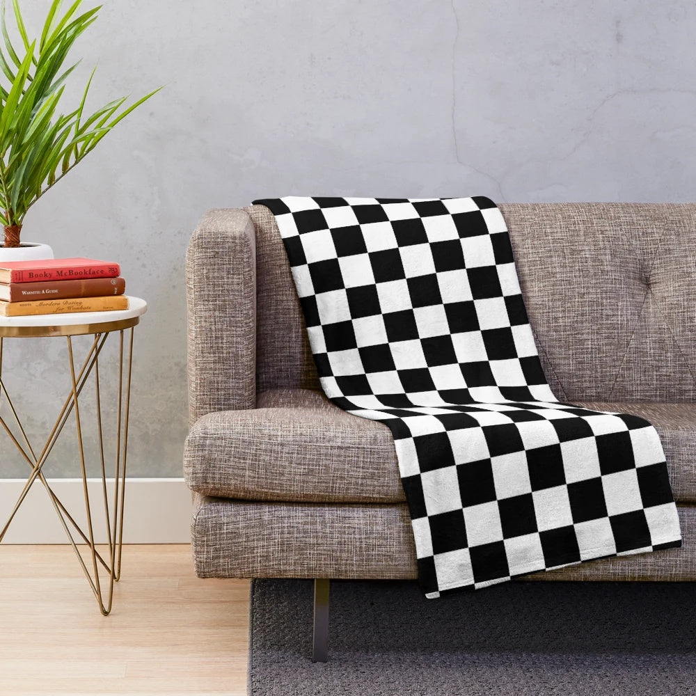 Checkered plush blanket in black and white geometric pattern